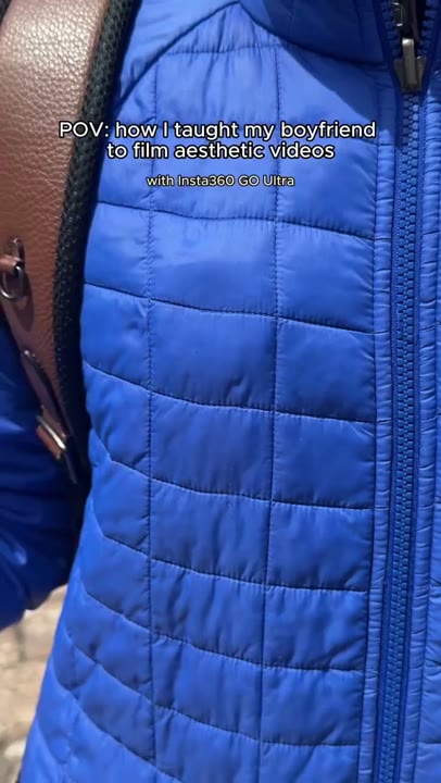 Frame at 3 seconds: A close-up reveals the small camera mounted on the blue jacket, followed by a wider shot as the creator moves away.