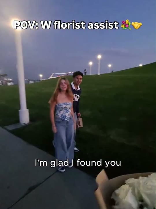 Frame at 2 seconds: The creator calls out to the approaching people: 'yo bro' and 'I'm glad I found you,' beneath the florist-assist…