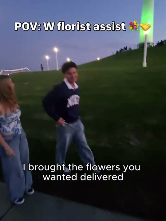 Frame at 3 seconds: The creator presents white flowers as an arranged delivery; the recipient smiles.