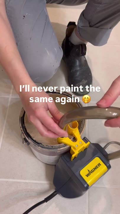 Frame at 2 seconds: An overhead close-up shows the hose being positioned at the paint can.