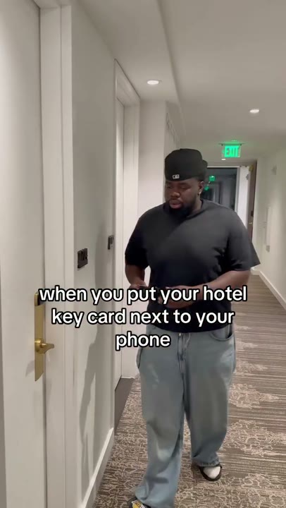 Frame at 2 seconds: The creator raises a phone and key card and looks at them with an open mouth.
