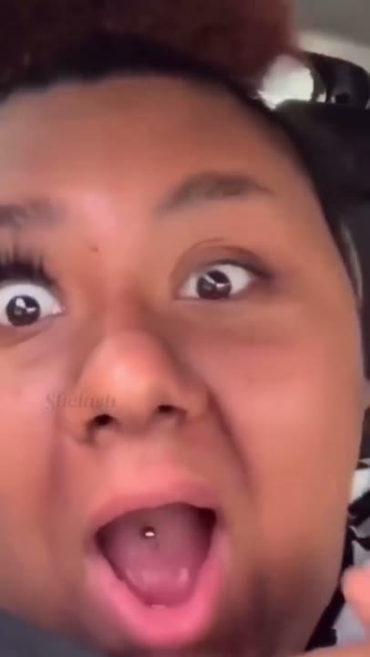 Frame at 2 seconds: The creator opens their eyes and mouth wide, then laughs, emphasizing one heavily lashed eye beside an apparently…