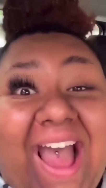 Frame at 3 seconds: The creator opens their eyes and mouth wide, then laughs, emphasizing one heavily lashed eye beside an apparently…