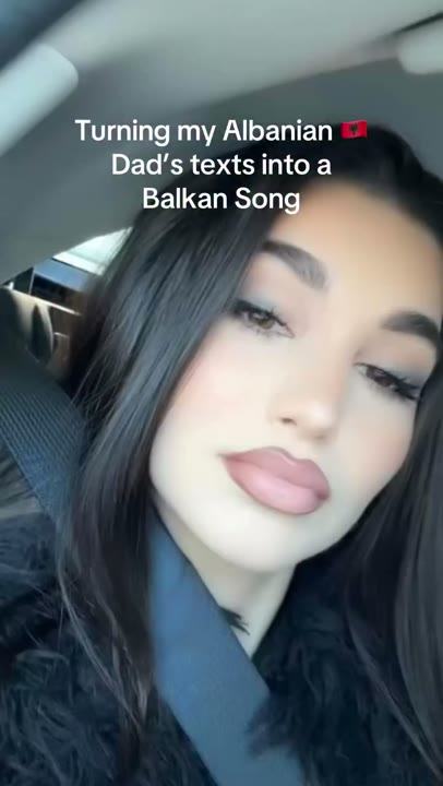 Frame at 0 seconds: Car selfie and an overlay announce the transformation of family texts into a Balkan song.