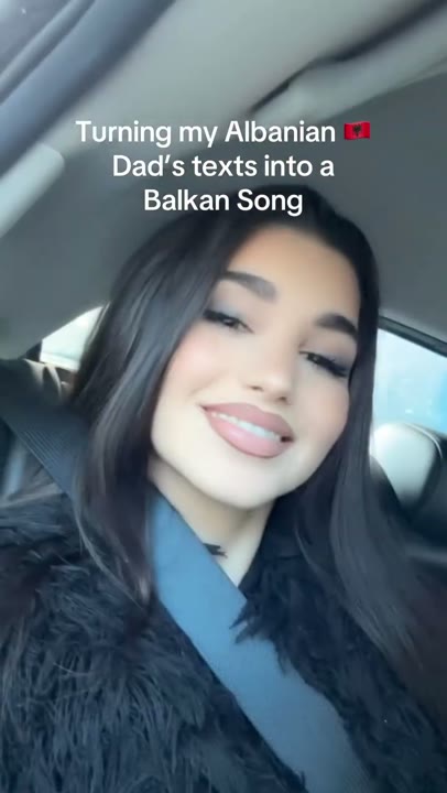 Frame at 1 seconds: Car selfie and an overlay announce the transformation of family texts into a Balkan song.
