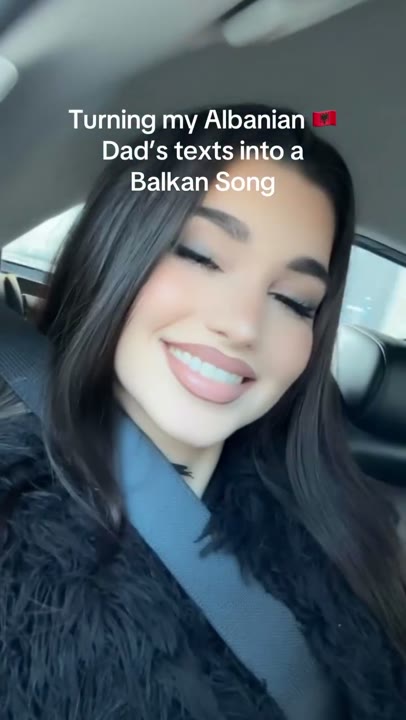 Frame at 2 seconds: Car selfie and an overlay announce the transformation of family texts into a Balkan song.
