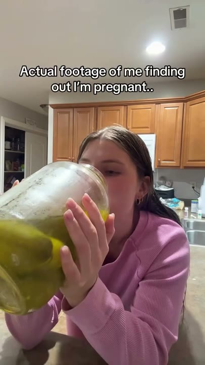 Frame at 2 seconds: The creator lifts the oversized jar and drinks directly from it.