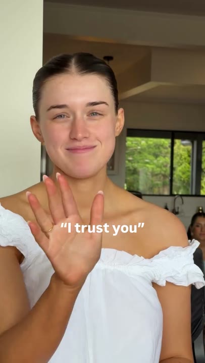 Frame at 1 seconds: The creator smiles and briefly waves beneath “I trust you.”