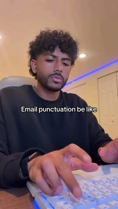 Frame at 1 seconds: The creator types beneath the persistent email-punctuation overlay.
