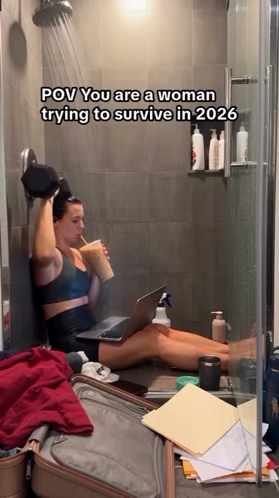Frame at 0 seconds: The creator drinks while raising and lowering a dumbbell beneath running shower water, with a laptop already open on…